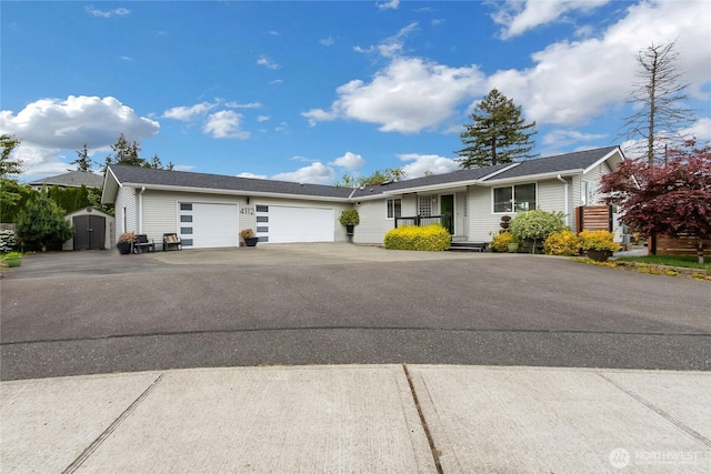 4112 Caldwell Rd E, Edgewood, WA 98372 - ranch-style house featuring a garage, a storage shed, asphalt driveway, and an outdoor structure