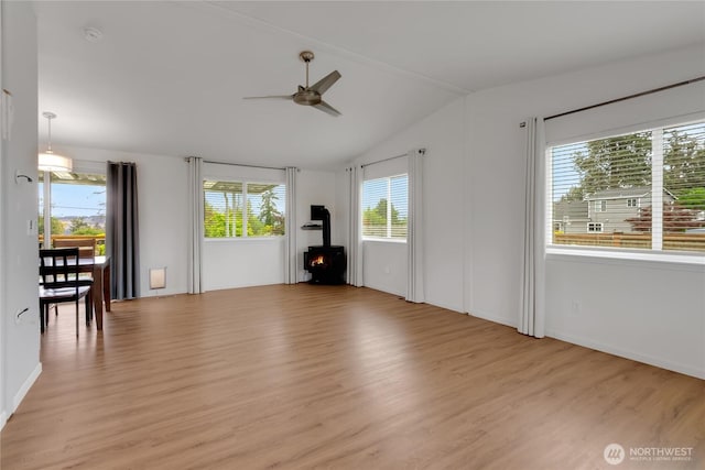 4112 Caldwell Rd E, Edgewood, WA 98372 - unfurnished living room featuring ceiling fan, healthy amount of natural light, light wood-style floors, a wood stove, and lofted ceiling