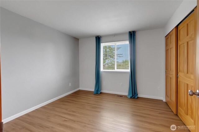 4112 Caldwell Rd E, Edgewood, WA 98372 - unfurnished bedroom with light wood-type flooring and baseboards