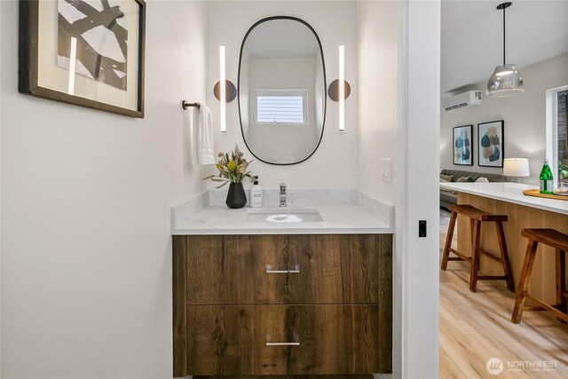 1740A NW 62nd St, Seattle, WA 98107 - bathroom featuring vanity, an AC wall unit, and wood finished floors