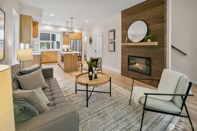 1740A NW 62nd St, Seattle, WA 98107 - living area with light wood-style flooring, a fireplace, baseboards, and recessed lighting