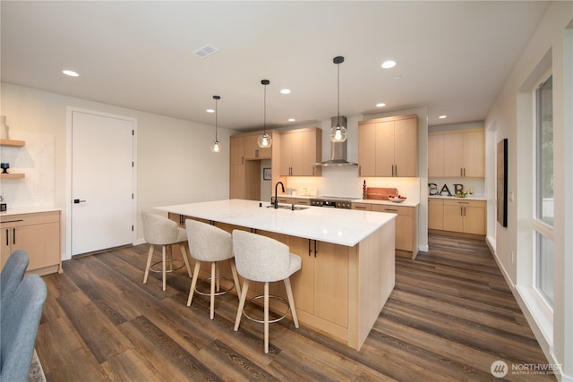 18809 94th Ave W, Edmonds, WA 98020 - kitchen with wall chimney exhaust hood, dark wood finished floors, recessed lighting, light countertops, and an island with sink