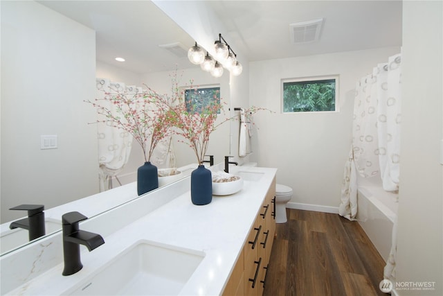 18809 94th Ave W, Edmonds, WA 98020 - full bath with wood finished floors, toilet, double vanity, baseboards, and shower / bath combination with curtain