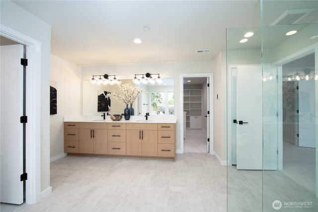18809 94th Ave W, Edmonds, WA 98020 - bathroom featuring a spacious closet, double vanity, baseboards, and recessed lighting