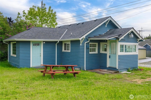 6312 S I St, Tacoma, WA 98408 - back of property featuring a shingled roof and a lawn