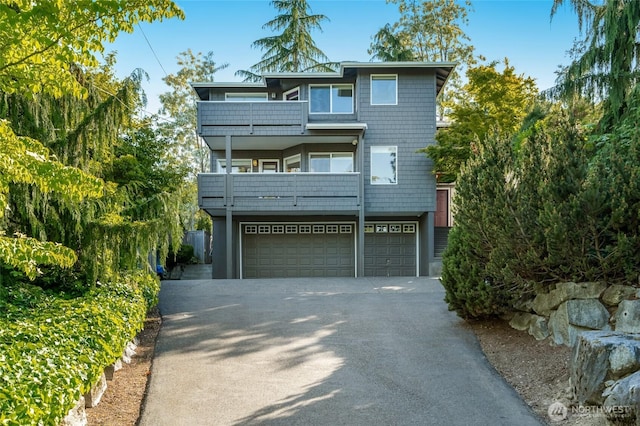12045 Lakeside Pl NE, Seattle, WA 98125 - view of front of house featuring a balcony, a garage, and asphalt driveway