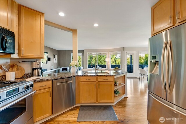 12045 Lakeside Pl NE, Seattle, WA 98125 - kitchen featuring stainless steel appliances, a sink, light wood-type flooring, dark stone countertops, and recessed lighting