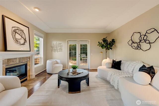 12045 Lakeside Pl NE, Seattle, WA 98125 - living area featuring french doors, a high end fireplace, light wood-style floors, and baseboards