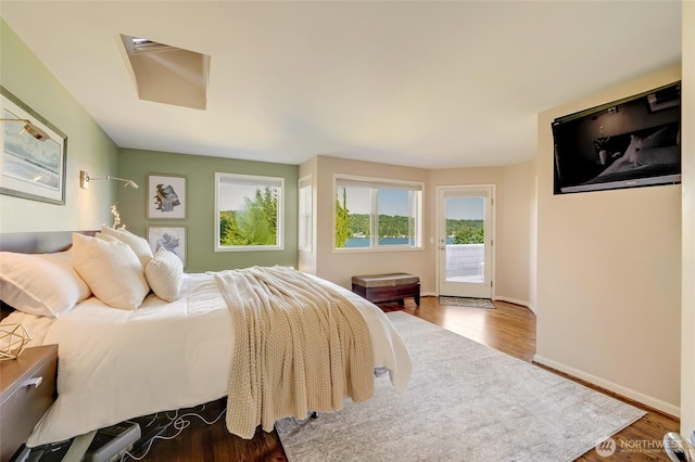 12045 Lakeside Pl NE, Seattle, WA 98125 - bedroom with access to exterior, wood finished floors, baseboards, and attic access