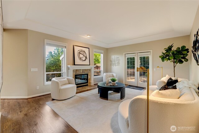 12045 Lakeside Pl NE, Seattle, WA 98125 - living room with french doors, wood finished floors, a high end fireplace, and baseboards