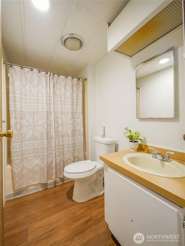 15712 123rd Ave SE, Yelm, WA 98597 - bathroom with wood finished floors, vanity, toilet, and shower / bath combo