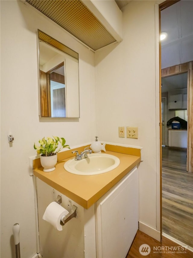 15712 123rd Ave SE, Yelm, WA 98597 - bathroom with wood finished floors, vanity, and baseboards