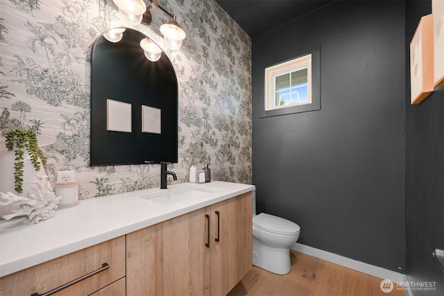 4964 Lewis Ave, Bellingham, WA 98229 - bathroom featuring wallpapered walls, wood finished floors, toilet, vanity, and baseboards