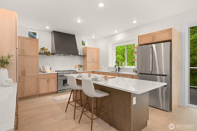 4964 Lewis Ave, Bellingham, WA 98229 - kitchen with stainless steel appliances, wall chimney range hood, a sink, light wood-style flooring, and recessed lighting
