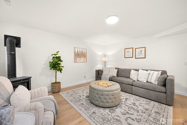 4964 Lewis Ave, Bellingham, WA 98229 - living area with a wood stove, light wood-type flooring, and baseboards