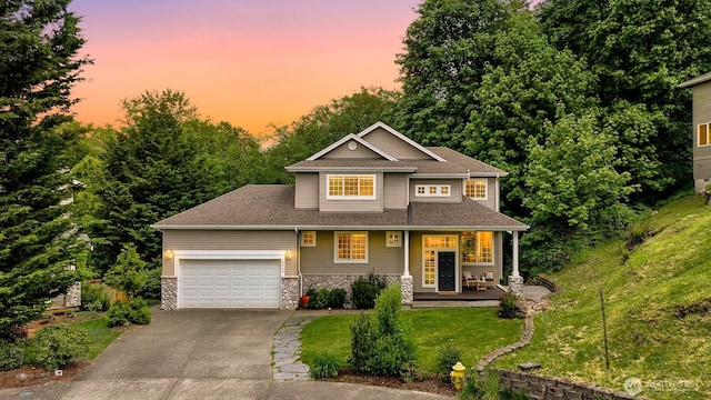 4964 Lewis Ave, Bellingham, WA 98229 - view of front facade featuring driveway, a front yard, an attached garage, stone siding, and covered porch