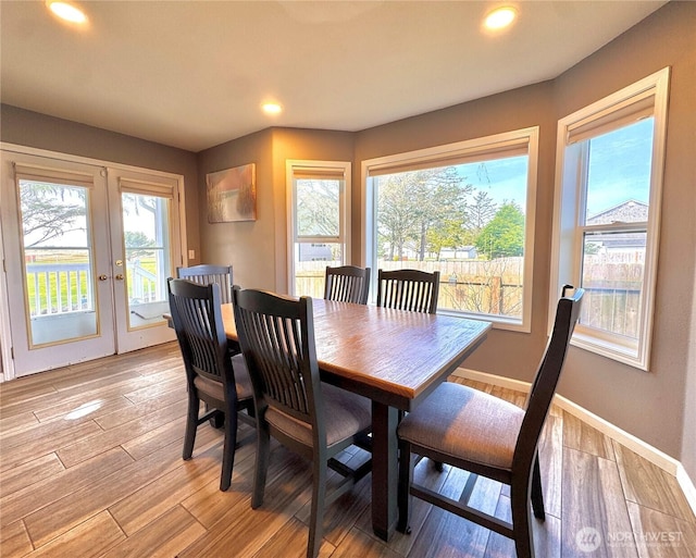2615 Sea Crest Ave N, Long Beach, WA 98631 - dining room featuring french doors, light wood finished floors, baseboards, and recessed lighting