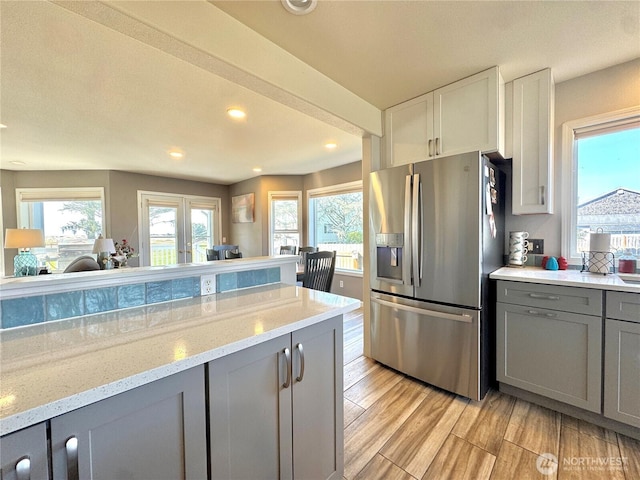 2615 Sea Crest Ave N, Long Beach, WA 98631 - kitchen with stainless steel fridge, gray cabinetry, light wood-style floors, recessed lighting, and light stone countertops