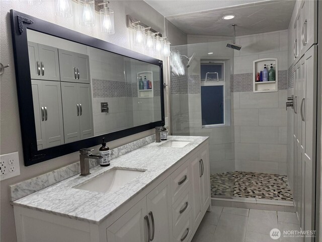 2615 Sea Crest Ave N, Long Beach, WA 98631 - bathroom with double vanity, a walk in shower, and tile patterned floors