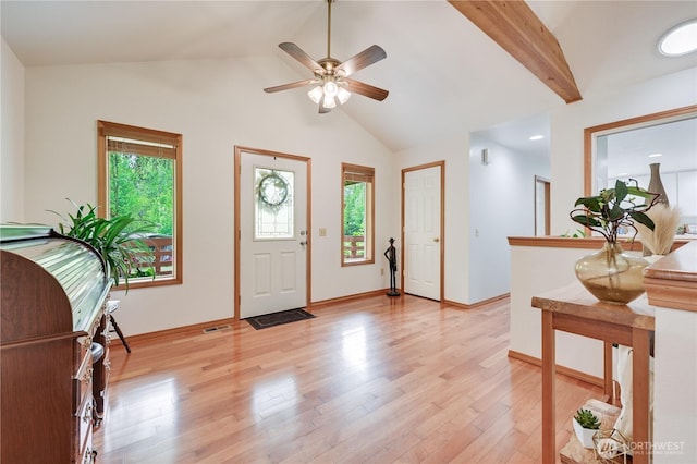 entrance foyer with plenty of natural light, light wood-style flooring, a ceiling fan, and baseboards