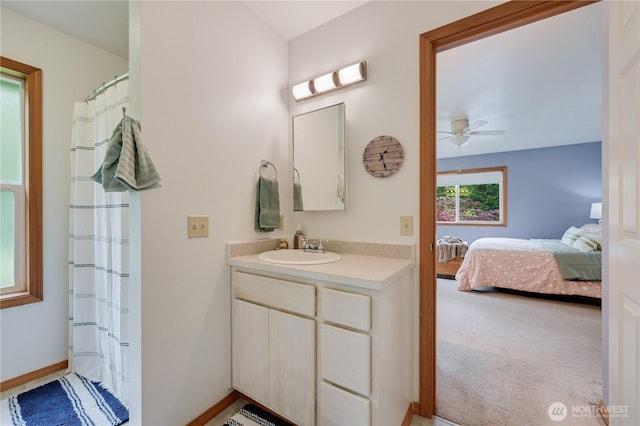 ensuite bathroom featuring vanity and a ceiling fan