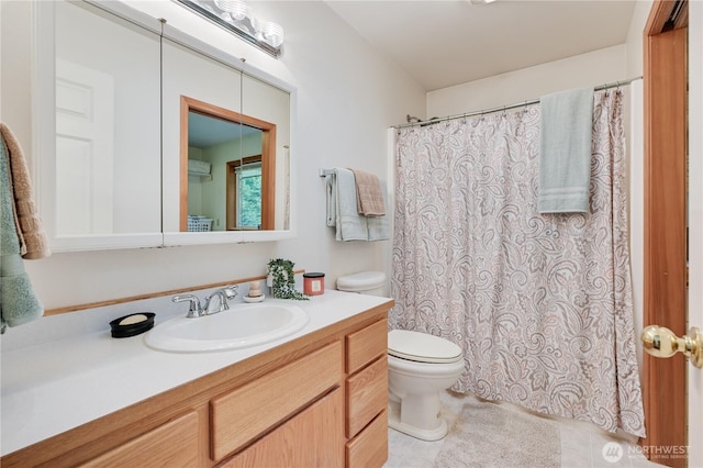 bathroom featuring toilet, vanity, tile patterned floors, and a shower with curtain