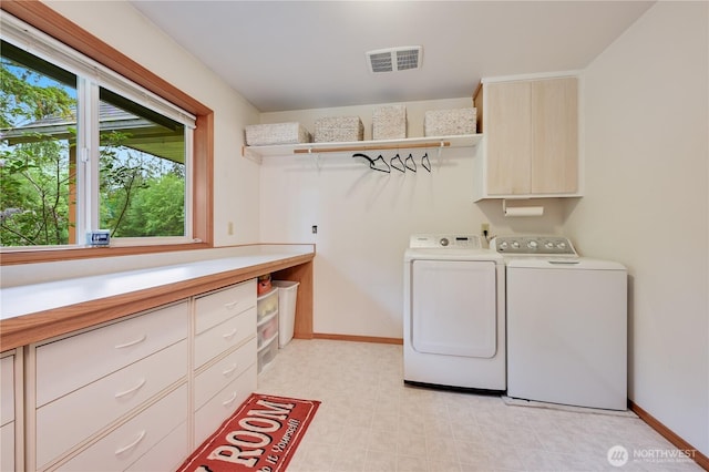 laundry area with washer and dryer, cabinet space, baseboards, and light flooring