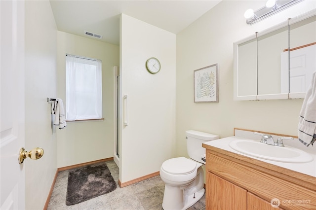 full bathroom with toilet, vanity, an enclosed shower, and baseboards