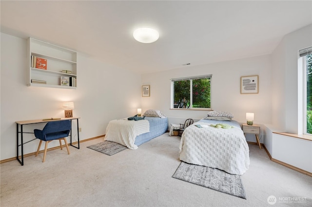 carpeted bedroom featuring baseboards