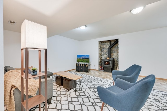 living area with a wood stove and baseboards