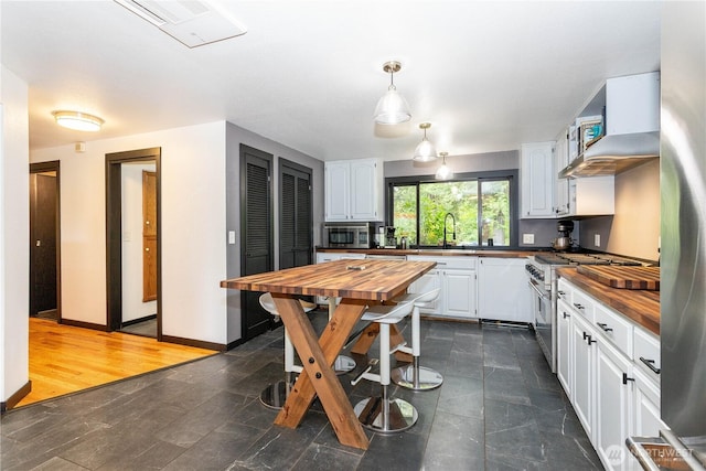 42520 State Route 2, Gold Bar, WA 98251 - kitchen featuring butcher block countertops, appliances with stainless steel finishes, and white cabinets