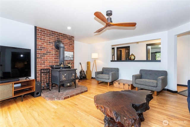 42520 State Route 2, Gold Bar, WA 98251 - living area featuring a wood stove, wood finished floors, a ceiling fan, and recessed lighting