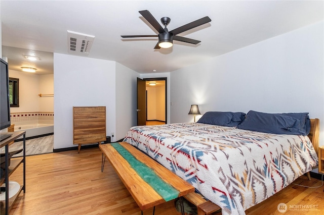 42520 State Route 2, Gold Bar, WA 98251 - bedroom with light wood finished floors, ceiling fan, and ensuite bathroom