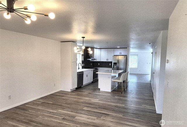 500 E Linden Ave, Moses Lake, WA 98837 - kitchen featuring appliances with stainless steel finishes, dark wood-style flooring, baseboards, light countertops, and decorative backsplash