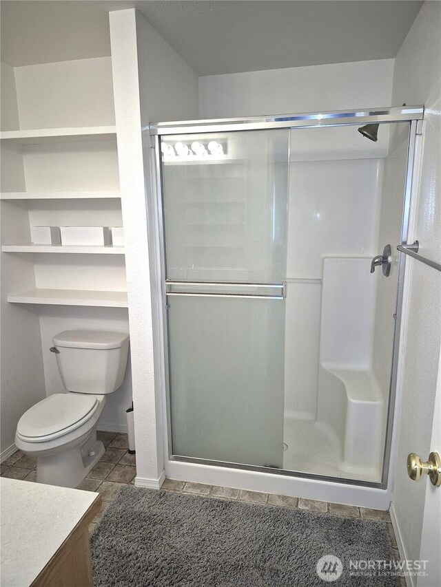 500 E Linden Ave, Moses Lake, WA 98837 - bathroom featuring tile patterned flooring, vanity, a shower stall, toilet, and baseboards