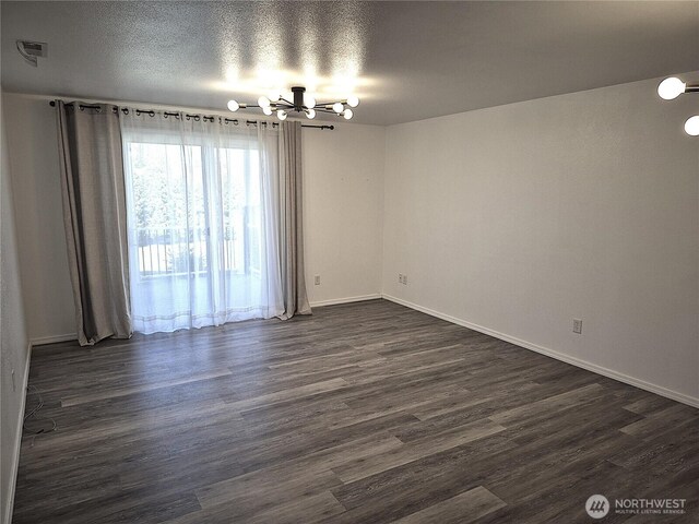 500 E Linden Ave, Moses Lake, WA 98837 - empty room with a chandelier, dark wood-type flooring, and baseboards