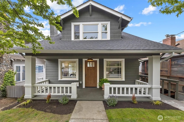 2711 10th Ave W, Seattle, WA 98119 - view of front of house featuring covered porch and a shingled roof
