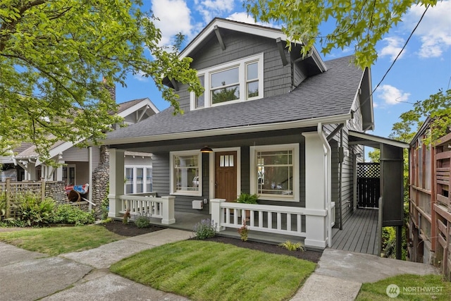 2711 10th Ave W, Seattle, WA 98119 - view of front of property featuring a shingled roof, a porch, and a front yard
