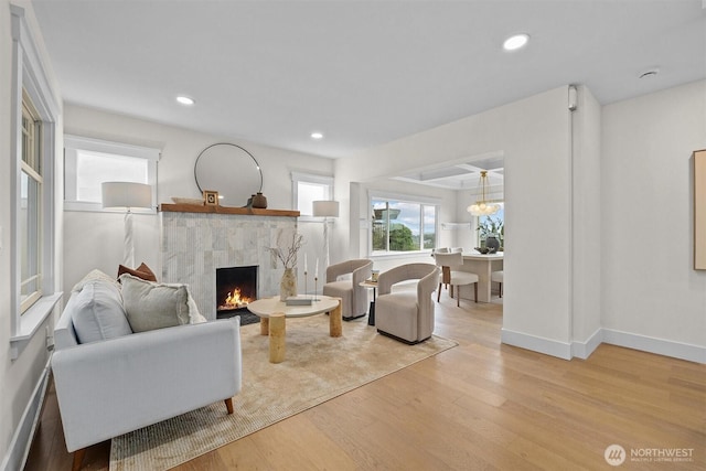 2711 10th Ave W, Seattle, WA 98119 - living area featuring wood finished floors, a tiled fireplace, baseboards, and recessed lighting