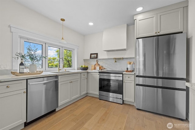 2711 10th Ave W, Seattle, WA 98119 - kitchen featuring appliances with stainless steel finishes, a sink, light countertops, and recessed lighting