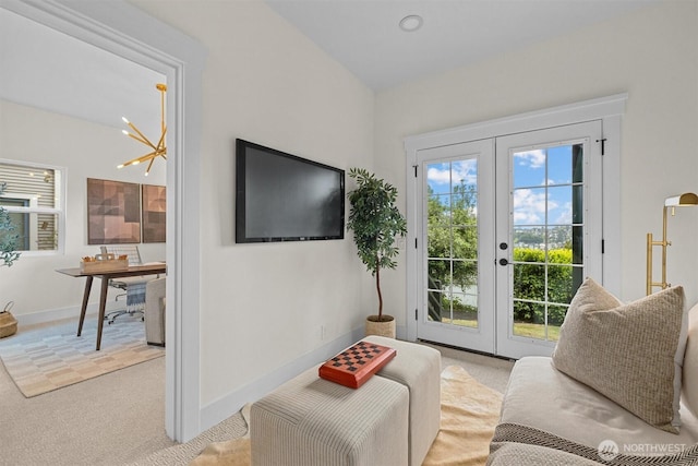 2711 10th Ave W, Seattle, WA 98119 - carpeted living area with a chandelier, french doors, and baseboards