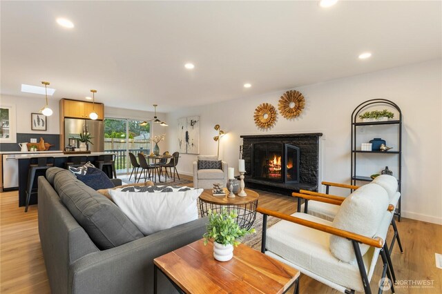1831 201st Pl SW, Lynnwood, WA 98036 - living room with a lit fireplace, recessed lighting, and light wood-style flooring