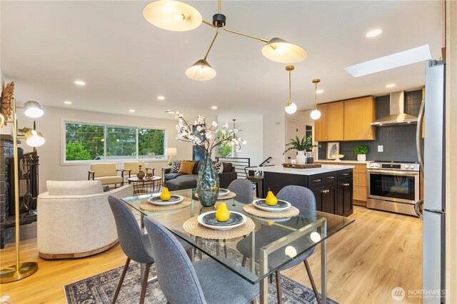 1831 201st Pl SW, Lynnwood, WA 98036 - dining space with light wood-type flooring, a skylight, and recessed lighting