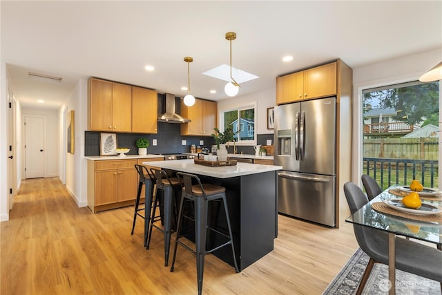 1831 201st Pl SW, Lynnwood, WA 98036 - kitchen featuring stainless steel fridge with ice dispenser, wall chimney exhaust hood, a center island, light countertops, and tasteful backsplash