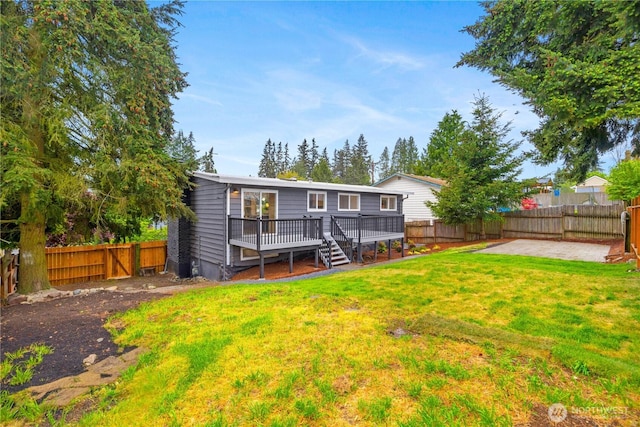 1831 201st Pl SW, Lynnwood, WA 98036 - rear view of property featuring a wooden deck, a fenced backyard, a patio area, and stairway