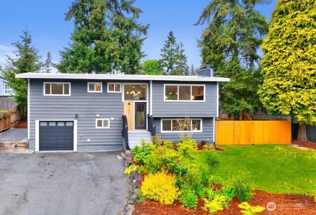 1831 201st Pl SW, Lynnwood, WA 98036 - split foyer home with an attached garage, driveway, a chimney, and entry steps