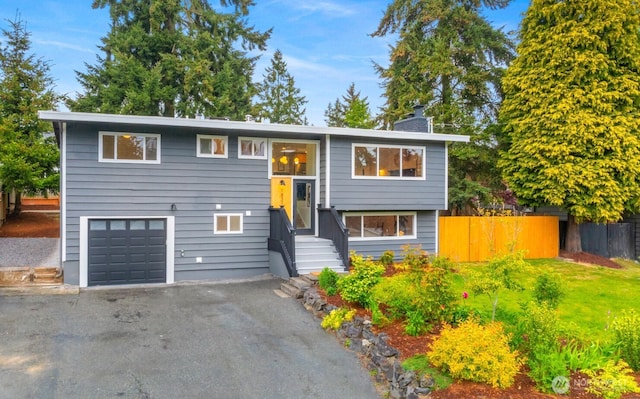1831 201st Pl SW, Lynnwood, WA 98036 - bi-level home with a chimney, an attached garage, driveway, and entry steps