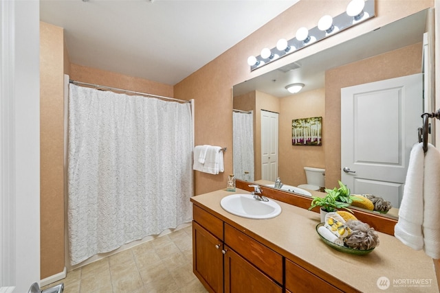 bathroom featuring tile patterned flooring, vanity, toilet, and a shower with curtain