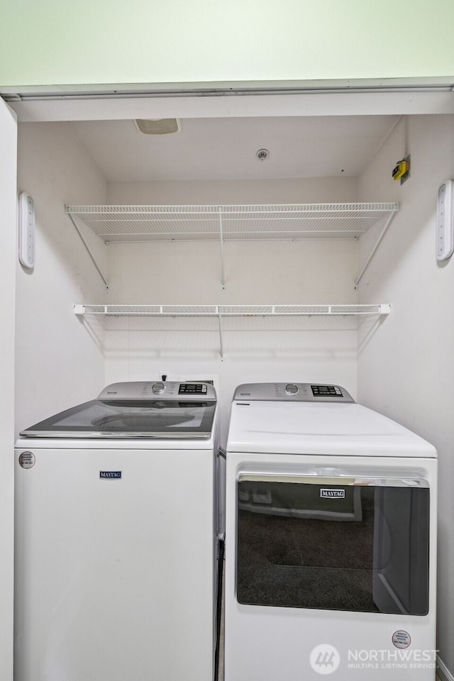 washroom with independent washer and dryer