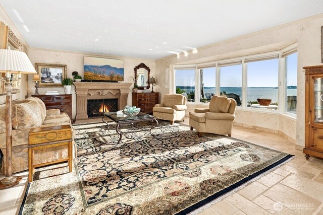 24635 8th Ave S, Des Moines, WA 98198 - living room featuring a water view, a warm lit fireplace, and stone tile floors
